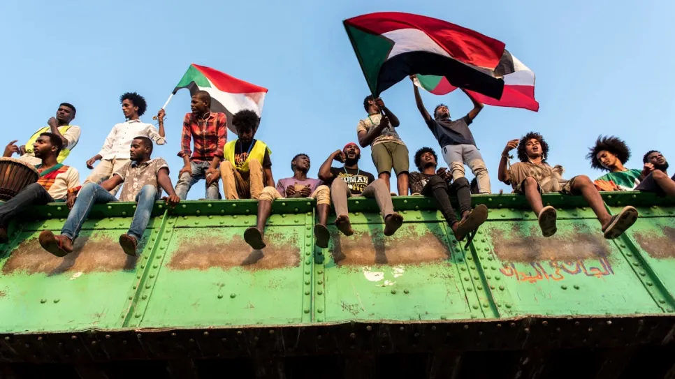 1559918292146-Sudanese-youth-wave-flags-and-chant-revolutionary-songs-on-the-morning-of-June-2-the-last-peaceful-morning-in-the-Khartoum-sit-in.jpg