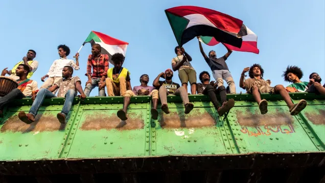 1559918292146-Sudanese-youth-wave-flags-and-chant-revolutionary-songs-on-the-morning-of-June-2-the-last-peaceful-morning-in-the-Khartoum-sit-in.jpg